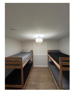 two bunk beds in a room with a ceiling at Soulistic Vibes Normandie in Los Angeles