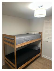 a bunk bed in a room with a ceiling at Soulistic Vibes Normandie in Los Angeles