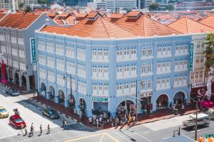 an overhead view of a large blue building on a city street at Hotel 81 Chinatown in Singapore +3 photos