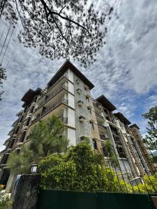 a large apartment building with a building at 1BR with Balcony Cool Breeze Morning Sun by Cherisia's Hideaway in Baguio