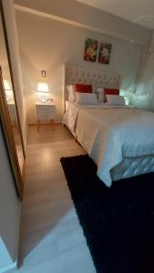 1 dormitorio con 1 cama grande y mesita de noche con lámpara en Luxury apartment, en Trujillo