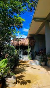 a building with a thatch roof and a patio at Ella Ceylonka in Ella +78 photos