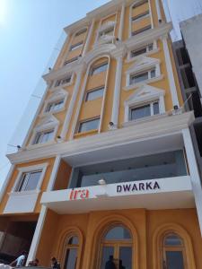 a yellow building with a sign in front of it at Ira by Orchid Dwarka in Dwarka