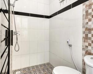 a bathroom with a shower and a toilet at Dhita Kubu in Kerobokan +13 photos