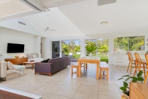 a living room with a couch and a table at Black Rocks Hideaway - 3BR Beach Home by uHoliday in Pottsville +13 photos