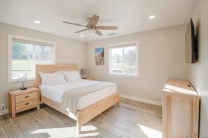 a bedroom with a bed and a ceiling fan at Dennison House in Three Rivers