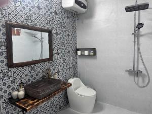 a bathroom with a toilet and a mirror and a shower at Wood Haven Homestay in Ninh Binh +89 photos