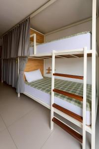 a bedroom with two bunk beds in a room at Green Sleep Hostel in Chiang Mai