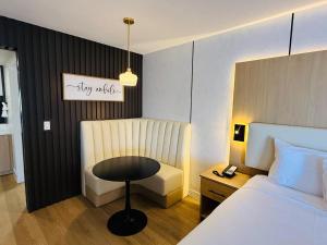 ビクタービルにあるMainStay Suites Victorville - Hesperiaのベッドとテーブルと椅子のある寝室