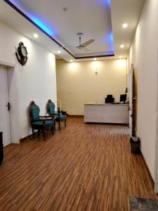 an office with chairs and a desk in a room at Perfect Lodge Guest House in Islamabad