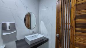 a white bathroom with a sink and a mirror at The River khaosok in Khao Sok +51 photos