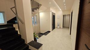 a hallway of a building with stairs and a stair case at Chippy Inn Tharamani in Chennai