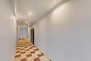 a hallway with a chessboard on the floor at Super Hotel O Deva Road Chinhat Formerly 24 Stays in Gomti Nagar