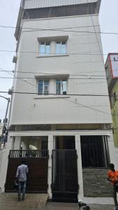 a man standing in front of a building at Chippy Inn Tharamani in Chennai
