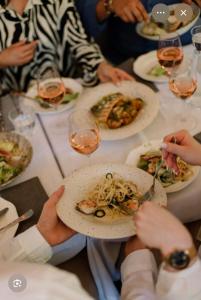 a group of people sitting at a table with plates of food at Hotel Red Plaza -Near Delhi Airport & Free Airport Drop in New Delhi