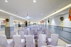 新德里Super Townhouse Yashobhoomi Formerly Hotel Grand Tashree的宴会厅的一排白色椅子