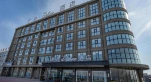 a large building with a lot of windows at Xana Deluxe Shangqiu Ancient Town in Shangqiu