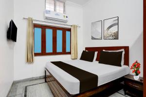 Postel nebo postele na pokoji v ubytování Super Hotel O Ujjawal Bhawan Formerly Anmol Residency + 19 fotografií