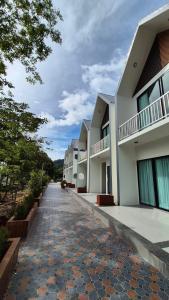 a cobblestone street in front of a building at The River khaosok in Khao Sok