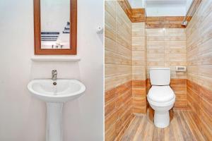 a bathroom with a toilet and a sink at Super Hotel O Dindugal Bus Terminal Formerly GK Building in Dindigul