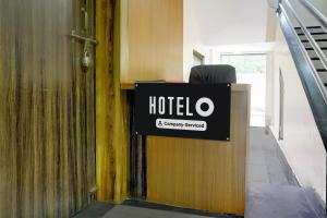 a sign for a hotel on the side of a building at Hotel O Sai Teerth Theme Park Formerly Sai Dhanlaxmi in Shirdi