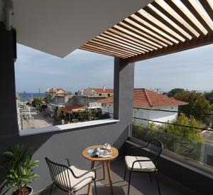 a balcony with a table and chairs and a view at Elegant Dream Suites in Ayia anna