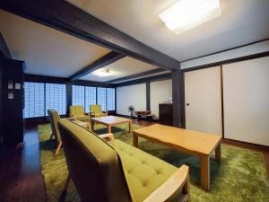 a living room with a table and chairs at 農家体験民宿 古民家 薄衣 in Ichinoseki