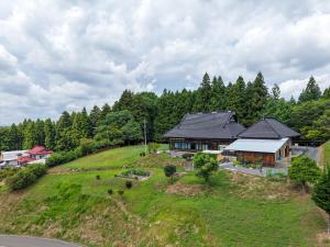an aerial view of a house on a hill at 農家体験民宿 古民家 薄衣 in Ichinoseki