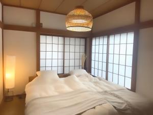 Ένα ή περισσότερα κρεβάτια σε δωμάτιο στο Usami Seaside