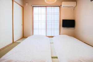 Ένα ή περισσότερα κρεβάτια σε δωμάτιο στο Sakuragawa-an Higashiyama