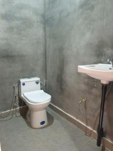 a bathroom with a toilet and a sink at Banlung Mountain View Treks & Tours in Banlung