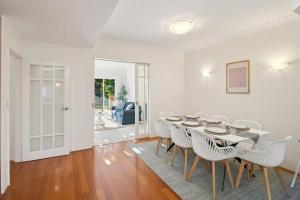 Kingsley Lake House 500Mbps Lakeside Wineries في بيرث: غرفة طعام بيضاء مع طاولة وكراسي