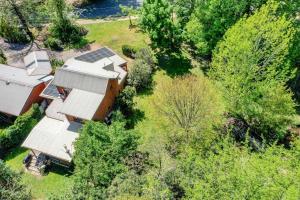 an overhead view of a house with solar panels and trees at Creek Haven in Bright