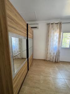 Cette chambre dispose d'une porte coulissante en verre et d'une fenêtre. dans l'établissement Grand T2 Bwereny'S Lodge - Passamainty, à Mamoudzou 3 autres photos