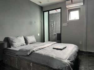 a bedroom with a large bed with a shower at Dalat Family Center in Da Lat