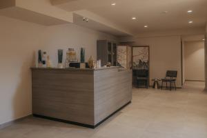 a lobby with a counter and chairs in a room at Shizen Wellness Hotel in Drama +92 photos