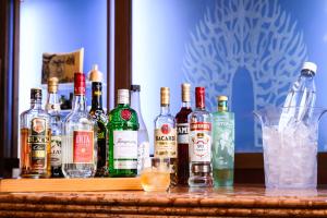 a group of bottles of alcohol sitting on a bar at Hotel Asyl Nara in Nara +38 photos