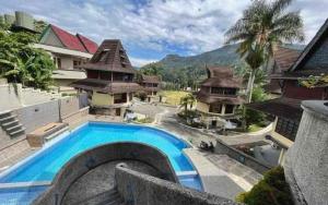 a resort with a swimming pool and some buildings at Sapadia Hotel Parapat in Parapat