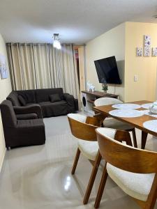a living room with a couch and a table and chairs at bonito departamento cerca al Aeropuerto Jorge Chávez in San Antonio