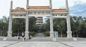une grande arche de pierre avec des gens assis en dessous dans l'établissement GreenTree Inn Express Hefei City Bus Station, à Feicheng