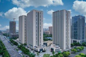 an aerial view of a city with tall buildings at GreenTree Inn Jinan West Station Exhibition Center in Jinan