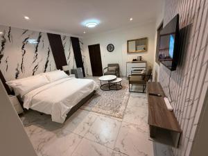 a bedroom with a bed and a television in it at The Benjamin Guest House in Edenvale