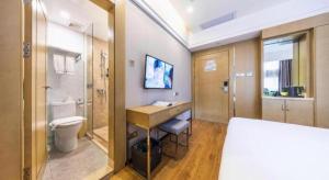 a room with a bathroom with a toilet and a sink at Xiang Mei Hotel - Jingtianbei Branch in Shenzhen
