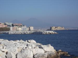 un gran grupo de rocas en el agua con edificios en Monolocale fronte strada Napoli centro storico, en Nápoles