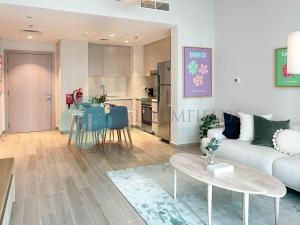 a living room with a couch and a table at Bloomfields Relaxing 1Br in Yas Island Waters Ed in Yas Island +5 photos