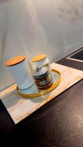 a plate with a jar and cups on a car at CasaKallisti in Levádeia