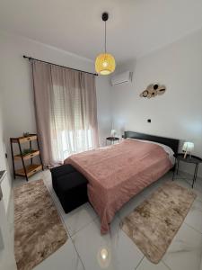 a bedroom with a large bed and a window at CasaKallisti in Levádeia