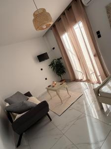 a living room with a couch and a table at CasaKallisti in Levádeia