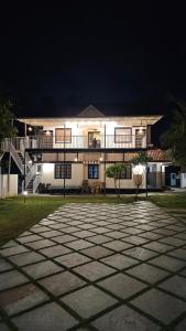 a large white building at night with a patio at Marari Beach Bella Casa in Alleppey