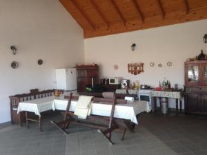 a kitchen with a table and chairs in a room at Kölcsey Kúria Vendégház in Szatmárcseke